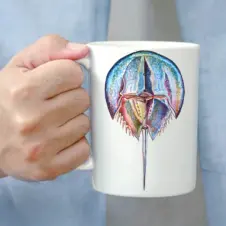 The Ship's Hold Watercolor Artwork 15oz Ceramic Mug, Colorful Horseshoe Crab (individual in hand)