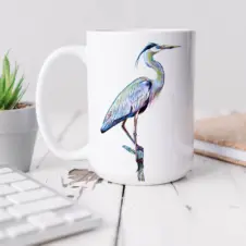 The Ship's Hold Watercolor Artwork 15oz Ceramic Mug, Heron on Branch (individual on table)