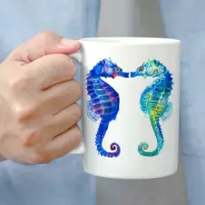 The Ship's Hold Watercolor Artwork 15oz Ceramic Mug, Kissing Seahorses (individual in hand)