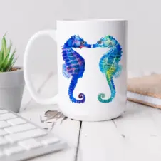 The Ship's Hold Watercolor Artwork 15oz Ceramic Mug, Kissing Seahorses (individual on table)