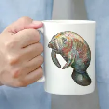 The Ship's Hold Watercolor Artwork 15oz Ceramic Mug, Manatee (individual in hand)