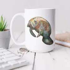 The Ship's Hold Watercolor Artwork 15oz Ceramic Mug, Manatee (individual on table)