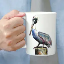 The Ship's Hold Watercolor Artwork 15oz Ceramic Mug, Pelican (individual in hand)