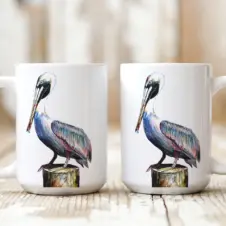 The Ship's Hold Watercolor Artwork 15oz Ceramic Mug, Pelican (pair on table)