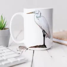 The Ship's Hold Watercolor Artwork 15oz Ceramic Mug, White Egret (individual on table)